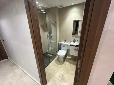 a bathroom with a shower and a toilet and a sink at Appartement à louer Eden Mansouria Residence in Mansouria