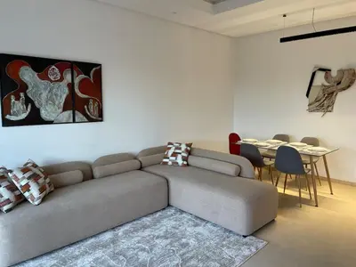 a living room with a couch and a table at Appartement Steps from Anfa Park Fanzone in Casablanca