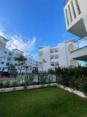 a view of an apartment building with a yard at Appartement Steps from Anfa Park Fanzone in Casablanca