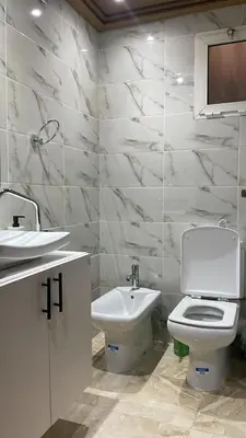 a bathroom with a white toilet and a sink at Apartment luxurious a Hay Riad in Rabat