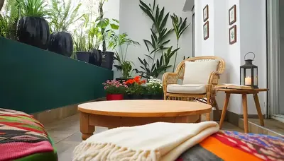 a room with a table and chairs and plants at Maya Suites - Cozy Flat with Terrace & Garden in Casablanca