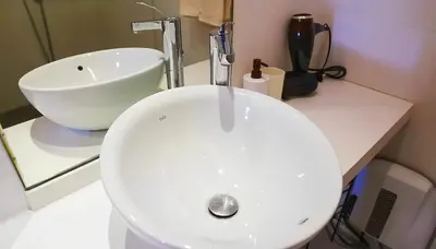 a bathroom with a white sink and a white bowl at Maya Suites - Cozy Flat with Terrace & Garden in Casablanca