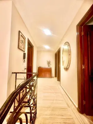a hallway with a staircase with a mirror on the wall at Luxurious Ocean View Villa Ain Diab in Casablanca
