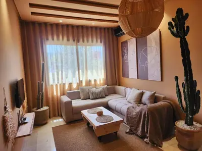 a living room with a couch and a cactus at Oasis de Sérénité avec Piscine in Casablanca