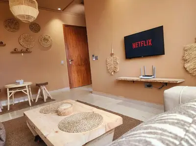 a living room with a couch and a table at Oasis de Sérénité avec Piscine in Casablanca