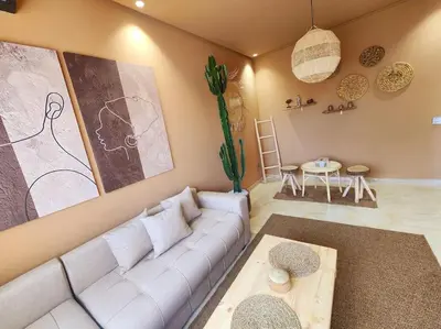 a living room with a white couch and a table at Oasis de Sérénité avec Piscine in Casablanca