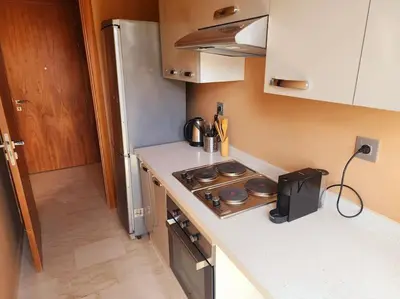 a small kitchen with a stove and a refrigerator at Oasis de Sérénité avec Piscine in Casablanca