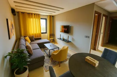 a living room with a couch and a table at Cosy-Piscine-Parking in Casablanca
