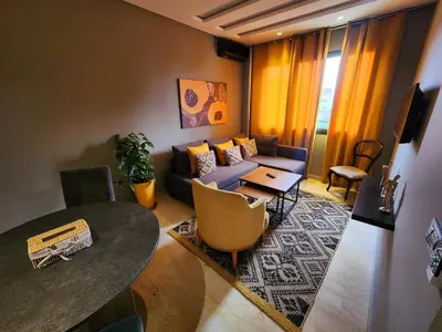 a living room with a couch and a table at Cosy-Piscine-Parking in Casablanca