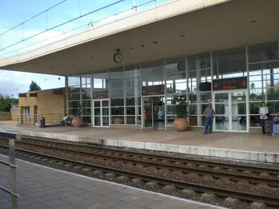 a train station with a person standing in front of a building at Cosy-Piscine-Parking in Casablanca