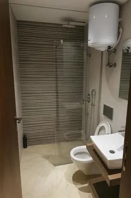 a bathroom with a shower and a toilet and a sink at Cozy 2-bedroom studio in Casablanca