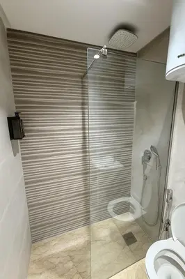 a shower with a glass door in a bathroom at Cozy 2-bedroom studio in Casablanca