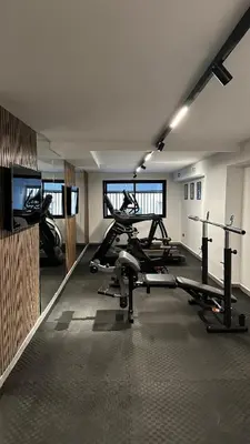 a gym with several tread machines in a room at studio luxe rooftop & gym quartier des princess in Casablanca