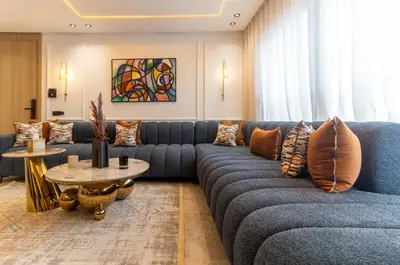 a living room with a blue couch and a table at Elegant Business Stay in Downtown Casablanca in Casablanca
