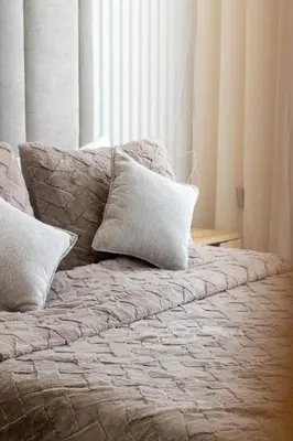 a bed with two pillows on it in a bedroom at Elegant Business Stay in Downtown Casablanca in Casablanca