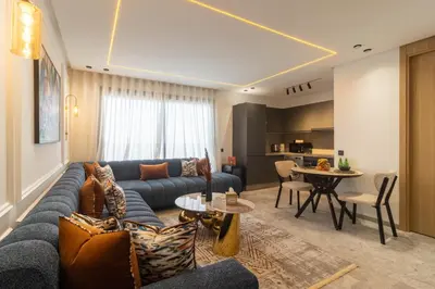 a living room with a blue couch and a table at Elegant Business Stay in Downtown Casablanca in Casablanca