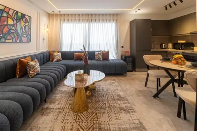 a living room with a blue couch and a table at Elegant Business Stay in Downtown Casablanca in Casablanca