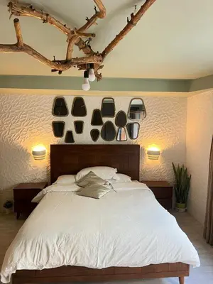 a bedroom with a large white bed with plates on the wall at stay in villa casablanca in Casablanca