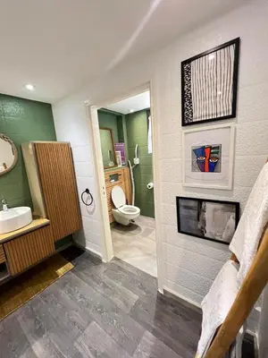 a bathroom with a toilet and a sink and a fireplace at stay in villa casablanca in Casablanca