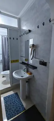 a white bathroom with a sink and a mirror at \u9526\u9ca4JinLi Voyageur in Casablanca