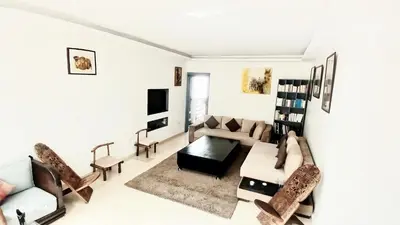 a living room with a couch and a table at Bel Appartement au cœur de Casablanca in Casablanca