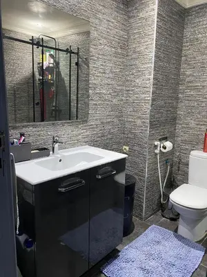 a bathroom with a sink and a toilet at Bel Appartement au cœur de Casablanca in Casablanca