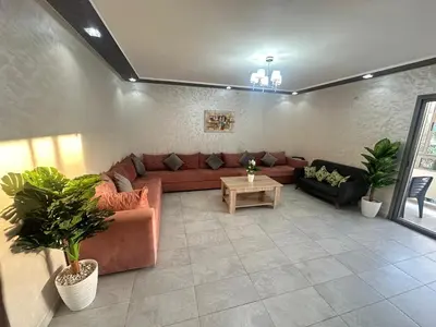 a living room with a couch and a table at Marbella beach residency in Mansouria