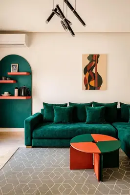 a living room with a green couch and a table at My Cosy Place Cosy Apartment Casa gare Oasis in LʼOasis
