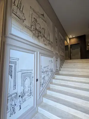 a staircase with drawings on the walls of a building at My Cosy Place Cosy Apartment Casa gare Oasis in LʼOasis
