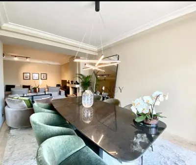 a dining room with a table and green chairs at Beautiful 2 suites apartment modern cozy and central in Casablanca
