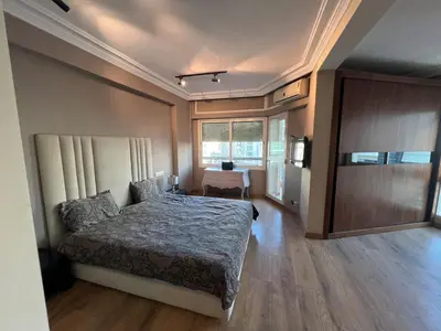 a bedroom with a bed and a desk in it at Beautiful 2 suites apartment modern cozy and central in Casablanca