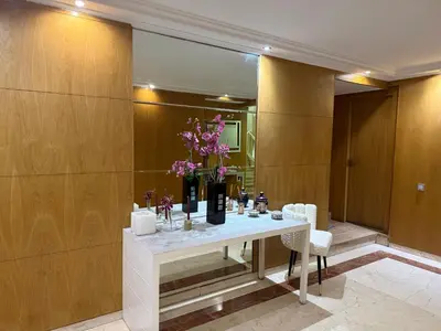 a room with a table with a vase of flowers at Beautiful 2 suites apartment modern cozy and central in Casablanca