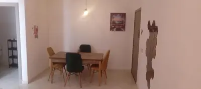 a dining room with a wooden table and chairs at Cosy studio dar bouazza in Casablanca
