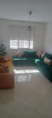 a living room with a green couch and chairs at Cosy studio dar bouazza in Casablanca