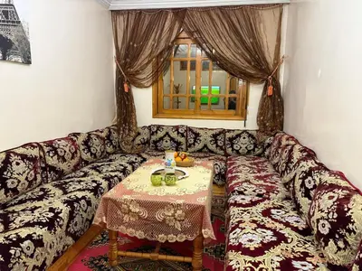 a living room with a couch with a table at family apartment in rabat in Rabat
