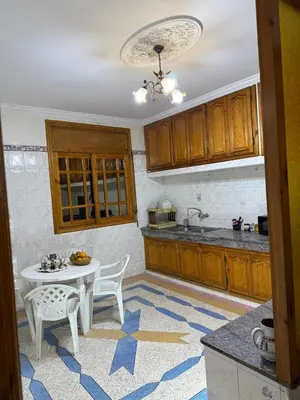 a kitchen with a table and chairs in a kitchen at family apartment in rabat in Rabat