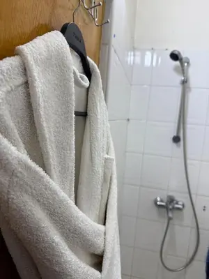 a white towel hanging on a wall in a bathroom at family apartment in rabat in Rabat
