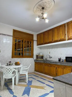 a kitchen with a table and chairs in a kitchen at family apartment in rabat in Rabat