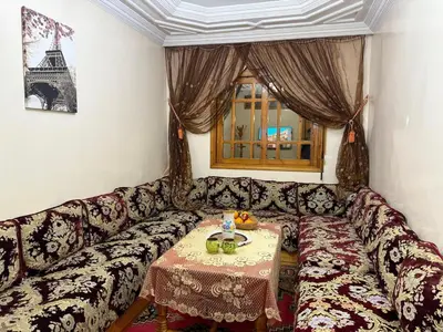 a living room with a couch with a table at family apartment in rabat in Rabat