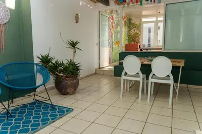 a kitchen with three chairs and a table in a room at Upper floor of a villa, Modern and bright in Rabat