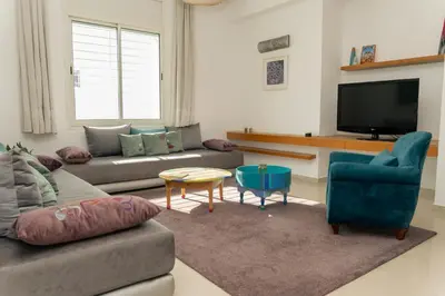 a living room with a couch and a tv at Upper floor of a villa, Modern and bright in Rabat