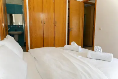 a white bed with two towels on top of it at Upper floor of a villa, Modern and bright in Rabat