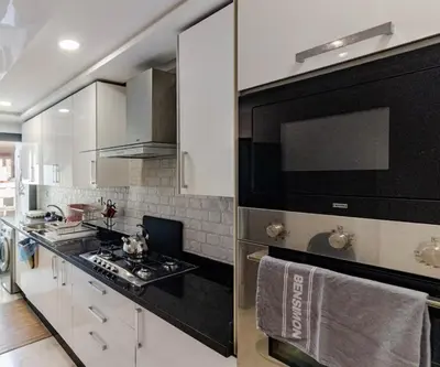 a kitchen with a black and white stove top oven at Large Comfort Duplex Casablanca Center in LʼOasis