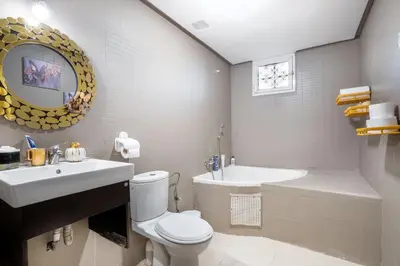 a bathroom with a toilet and a sink and a tub at Sophia Atlantis Pool Patio Garage in Mohammedia