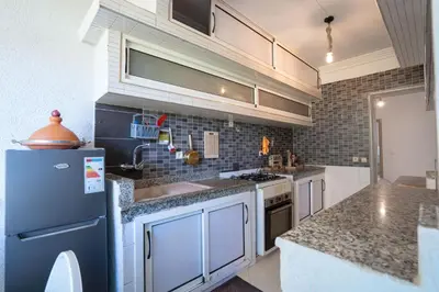 a kitchen with a sink and a refrigerator at Sophia Atlantis Pool Patio Garage in Mohammedia