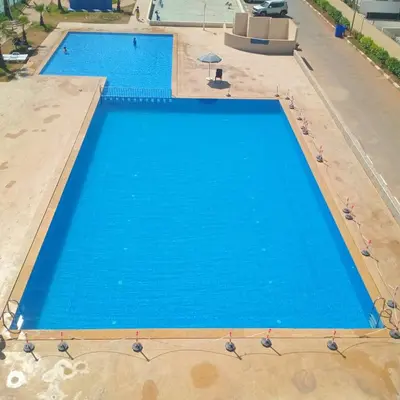 an overhead view of two swimming pools with blue water at Sophia Atlantis Pool Patio Garage in Mohammedia