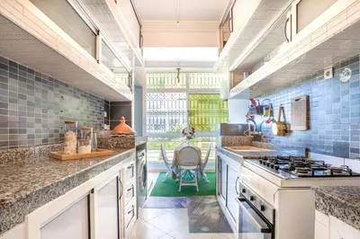 a kitchen with blue tiles and a stove at Sophia Atlantis Pool Patio Garage in Mohammedia