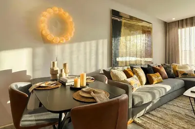 a living room with a couch and a table at Maya Suites - Mohamed V Stadium - Casablanca in Casablanca