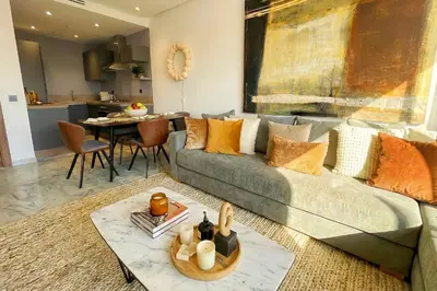 a living room with a couch and a table at Maya Suites - Mohamed V Stadium - Casablanca in Casablanca