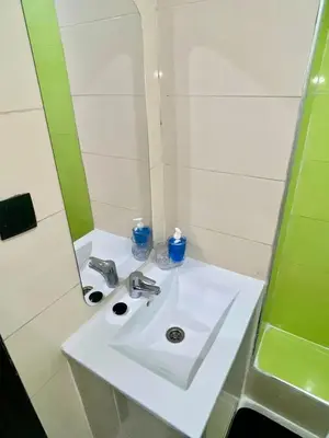 a white sink in a bathroom with a mirror at Le bon coin in Casablanca